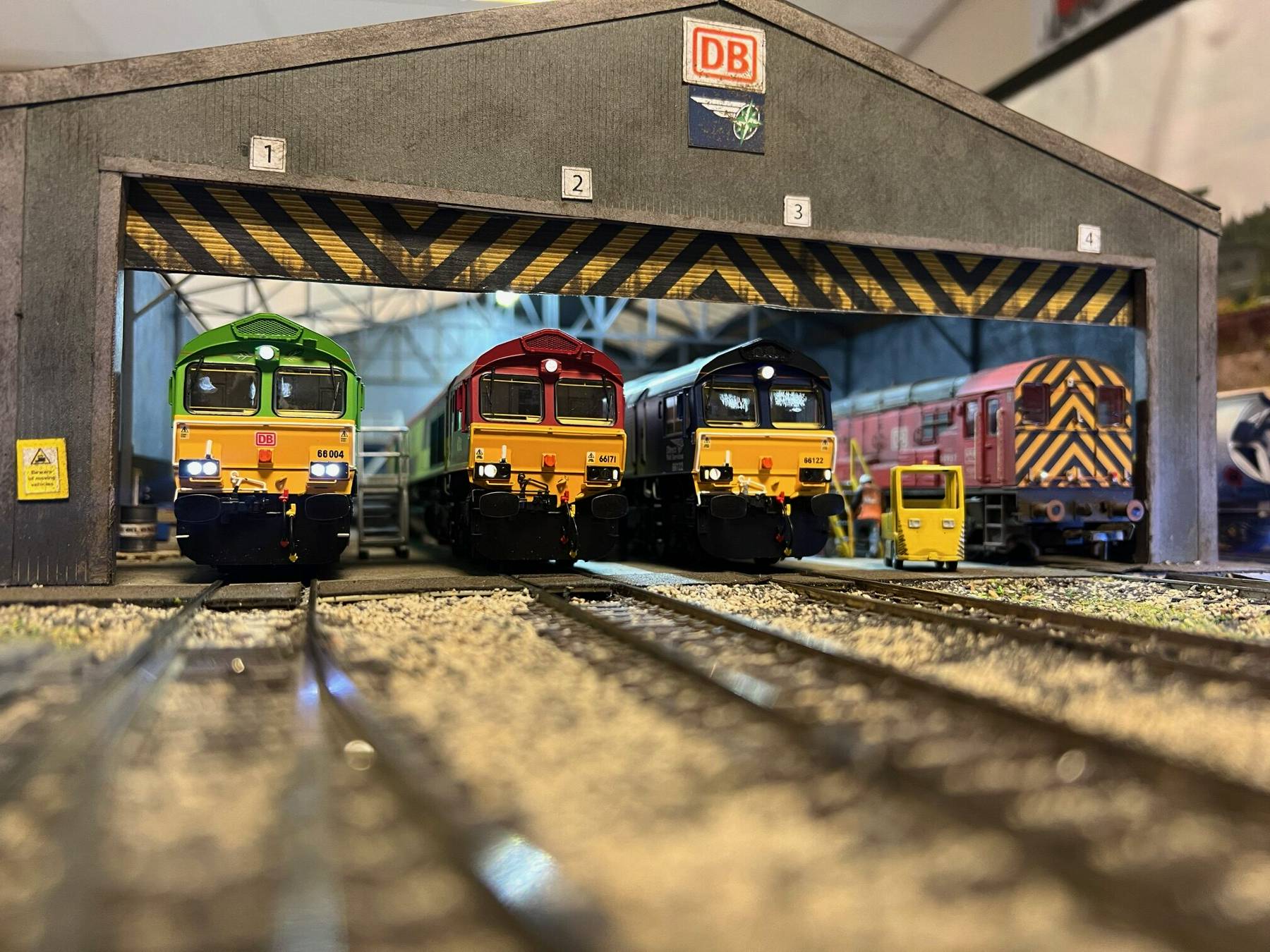 Three model trains in shed