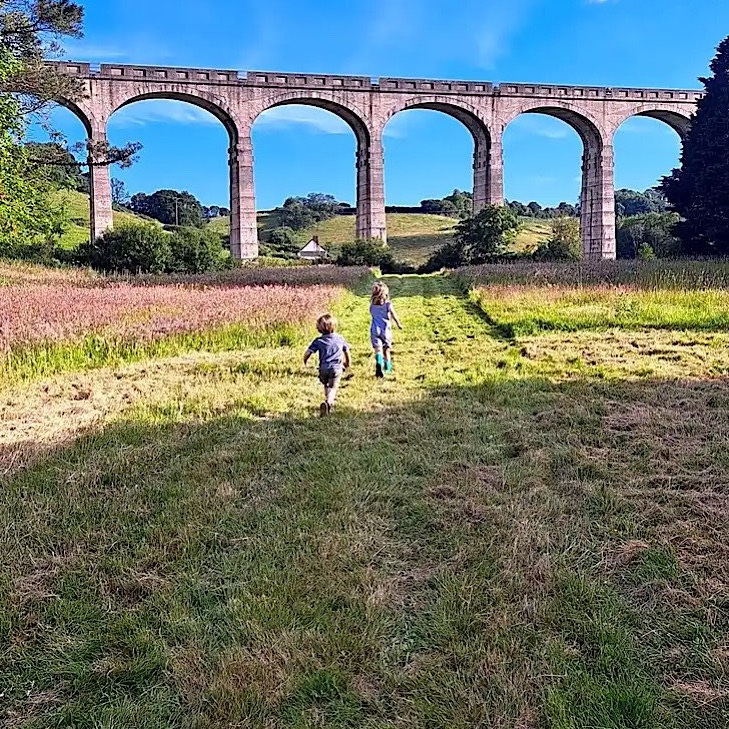  Children running towards viaduct
